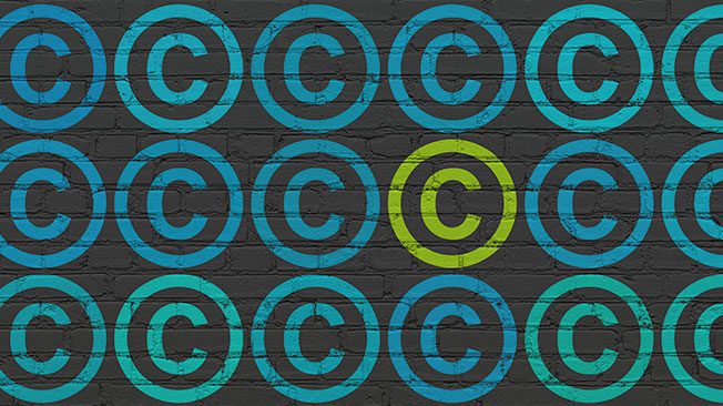 Copyright Law graphic - copyright symbol painted repeatedly on brick wall