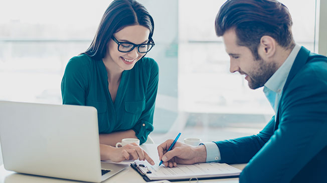 Contracting-and-royalties-FI A woman and man filling out a form together