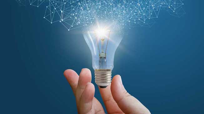 Hand holding lightbulb
