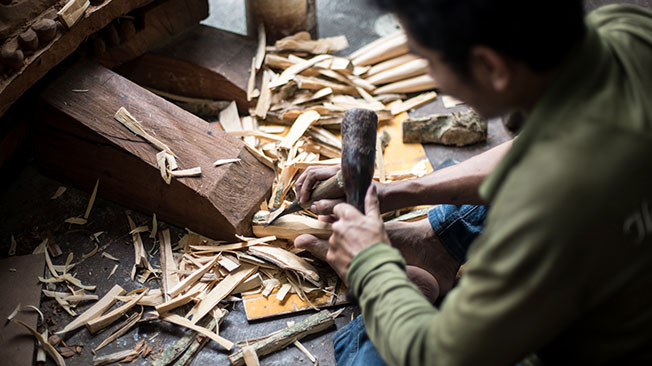 Visual Artists graphic - man making something out of wood