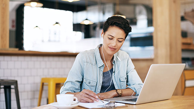 Writers graphic - woman on laptop making notes