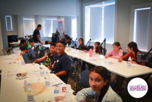 kids drawing storyboards as part of a workshop shession